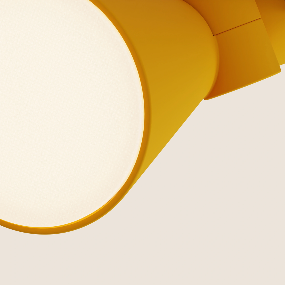 The mustard Aim Clamp Light from Gantri close up.
