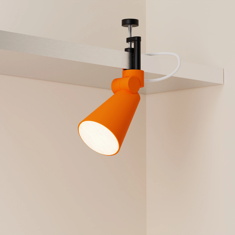 The persimmon Aim Clamp Light from Gantri with the black clamp.