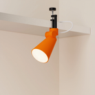 The persimmon Aim Clamp Light from Gantri with the black clamp.