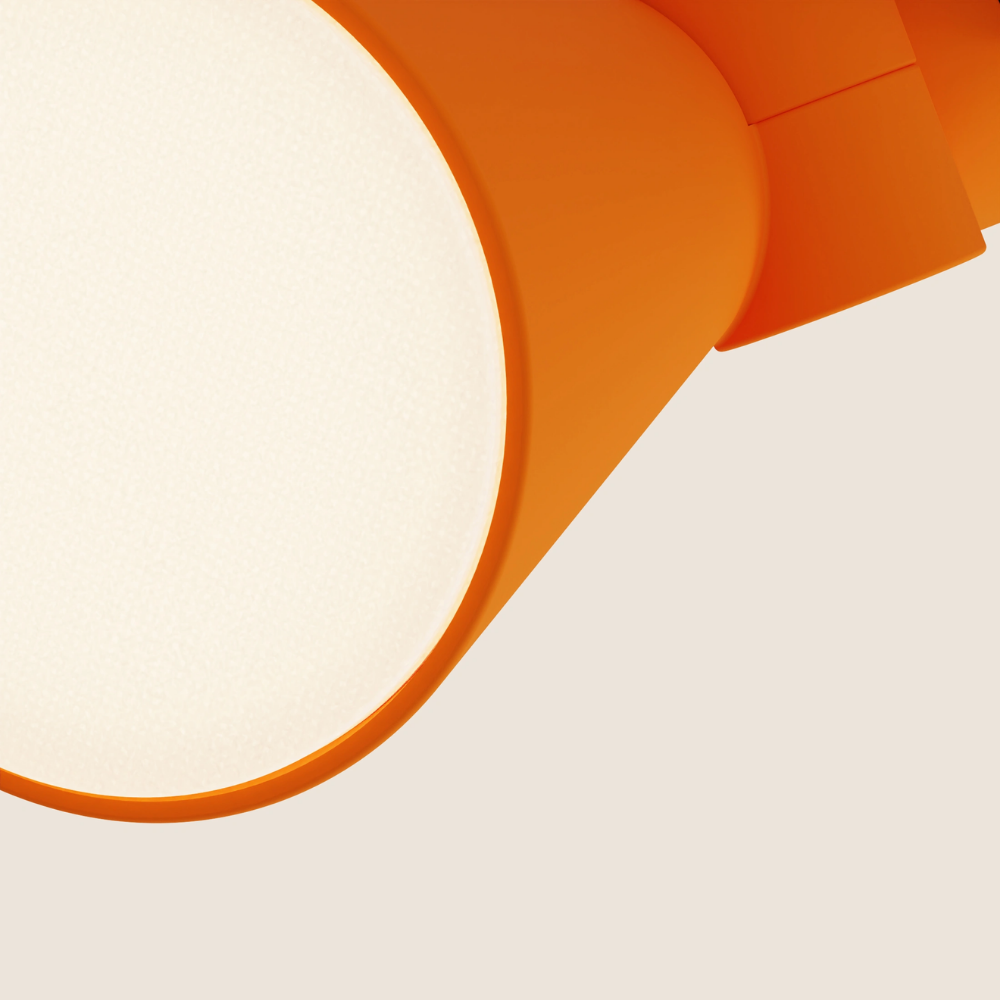 The persimmon Aim Clamp Light from Gantri close up.