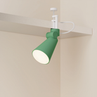 The sage Aim Clamp Light from Gantri with the white clamp.