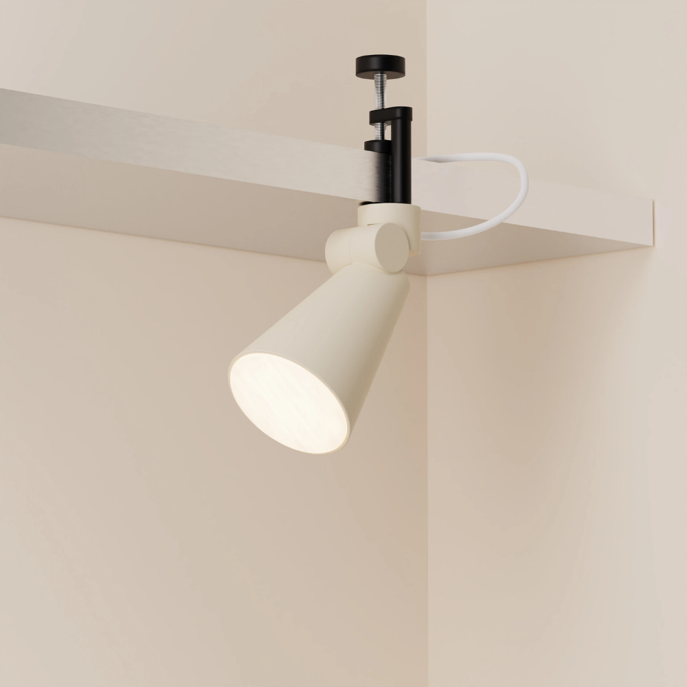 The sand Aim Clamp Light from Gantri with the black clamp.