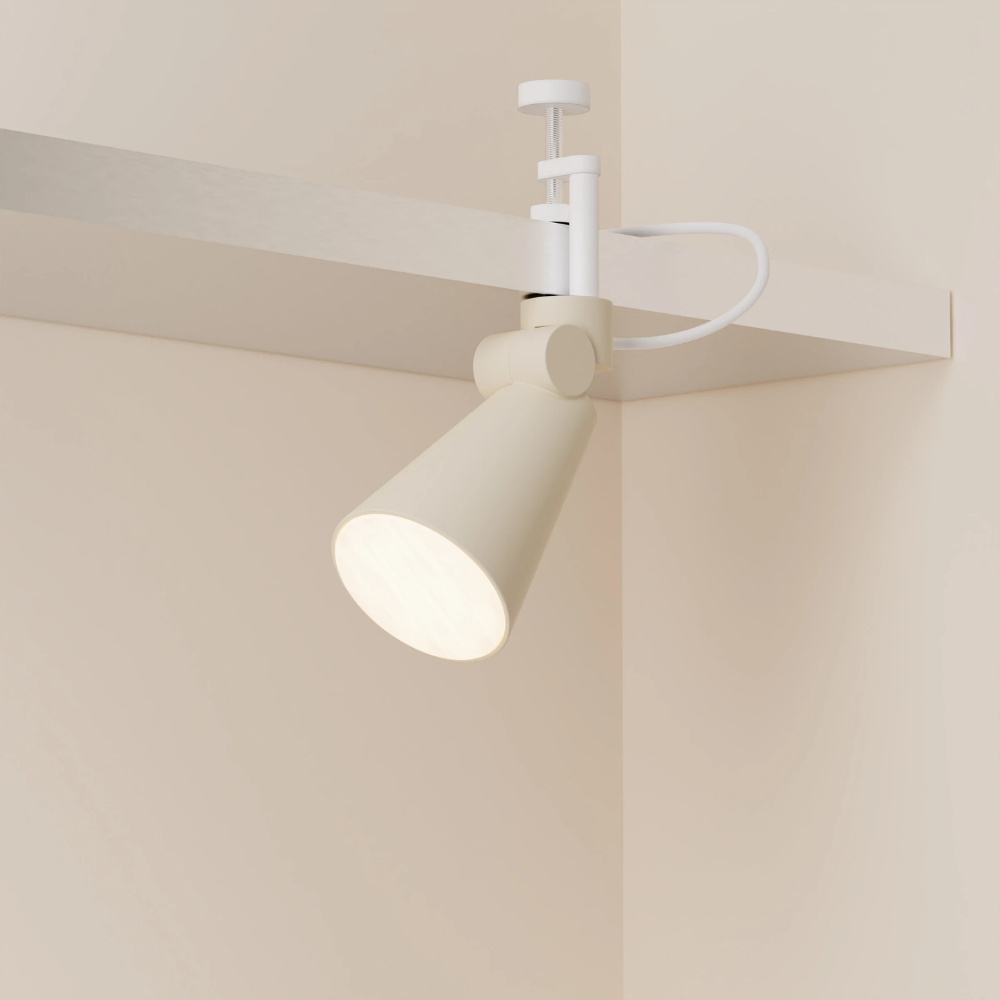 The sand Aim Clamp Light from Gantri with the white clamp.