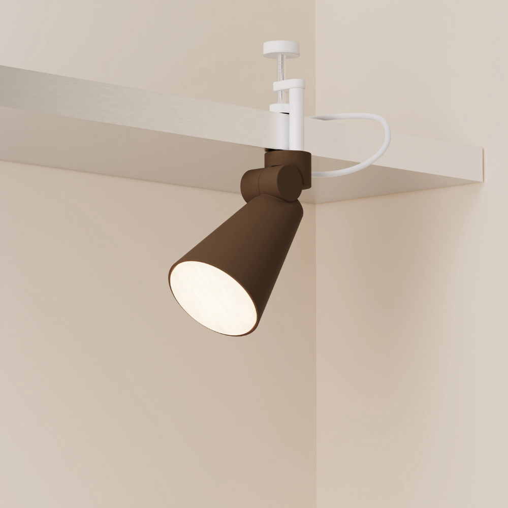 The walnut Aim Clamp Light from Gantri with the white clamp.