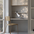 The snow Aim Clamp Light from Gantri with the black clamp in a home office.