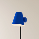 The cobalt Aim Floor Light from Gantri with the black rod option.