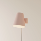 The coral Aim Floor Light from Gantri with the white rod option.