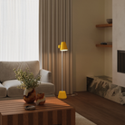 The mustard Aim Floor Light from Gantri with the white rod option in a living room next to a couch.