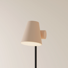 The peach Aim Floor Light from Gantri with the black rod option.
