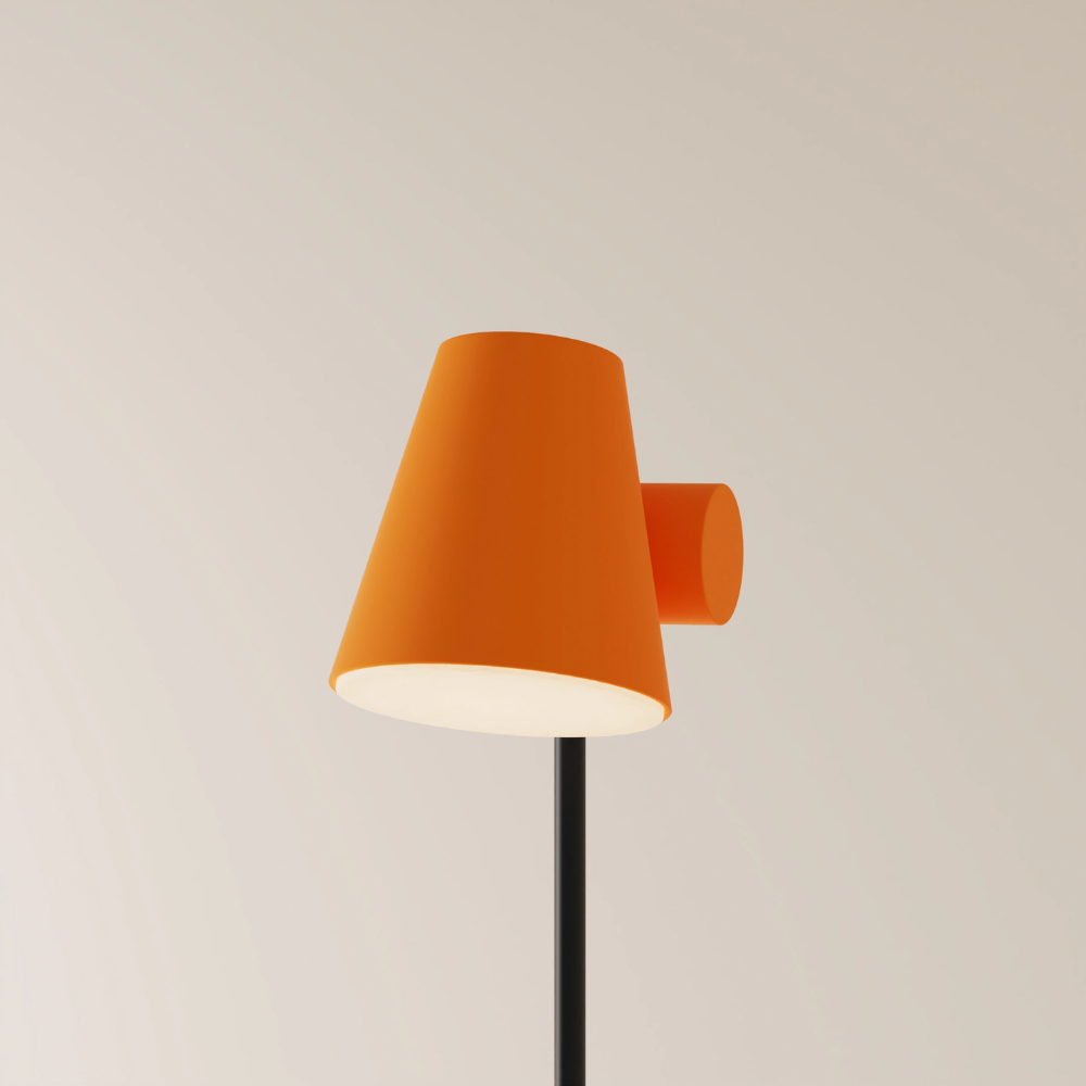 The persimmon Aim Floor Light from Gantri with the black rod option.