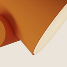 The persimmon Aim Floor Light from Gantri close up.