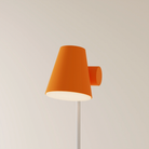The persimmon Aim Floor Light from Gantri with the white rod option.