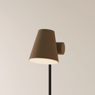 The walnut Aim Floor Light from Gantri with the black rod option.