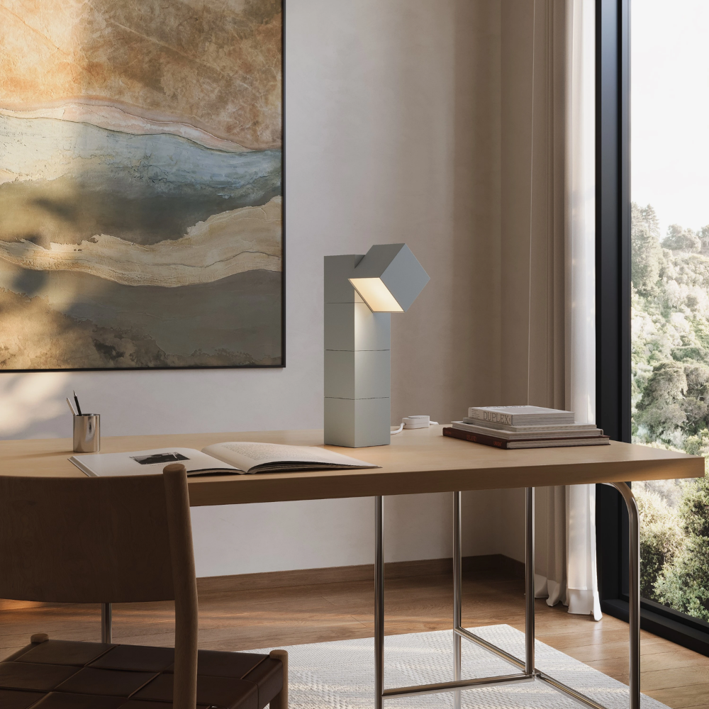 The mist Analog Task Light from Gantri in a home office on top of a desk.
