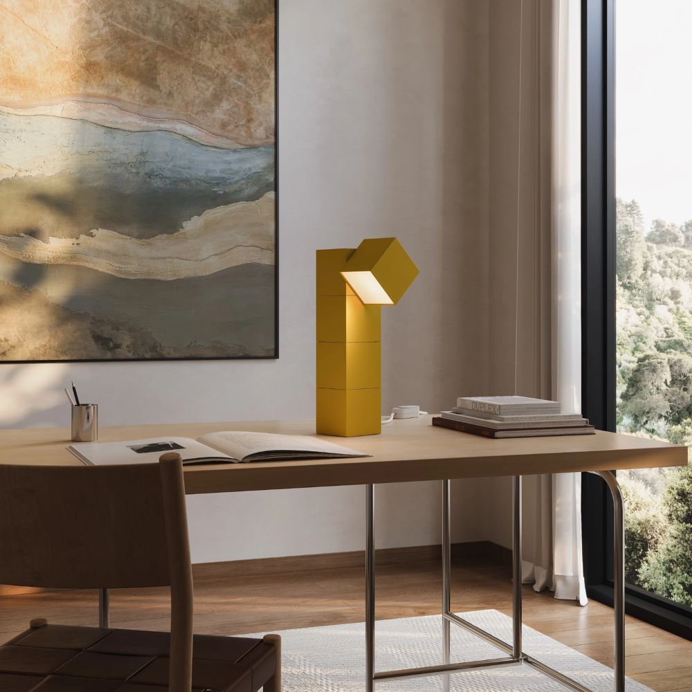 The mustard Analog Task Light from Gantri in a home office on top of a desk.