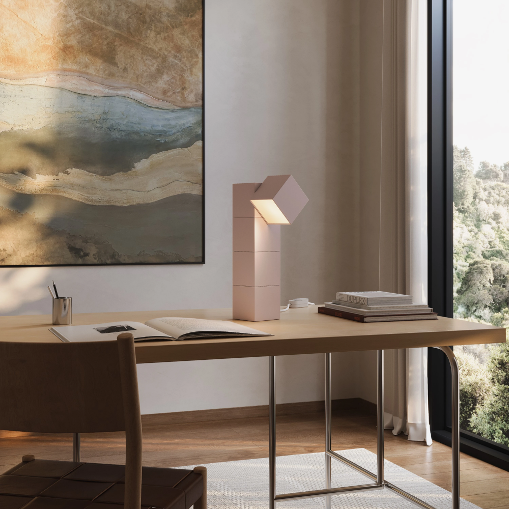 The peach Analog Task Light from Gantri in a home office on top of a desk.