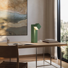 The sage Analog Task Light from Gantri in a home office on top of a desk.