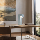 The sky Analog Task Light from Gantri in a home office on top of a desk.