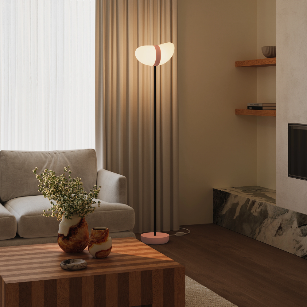 The blossom Baltra Floor Light from Gantri with the black rod option in a living room.