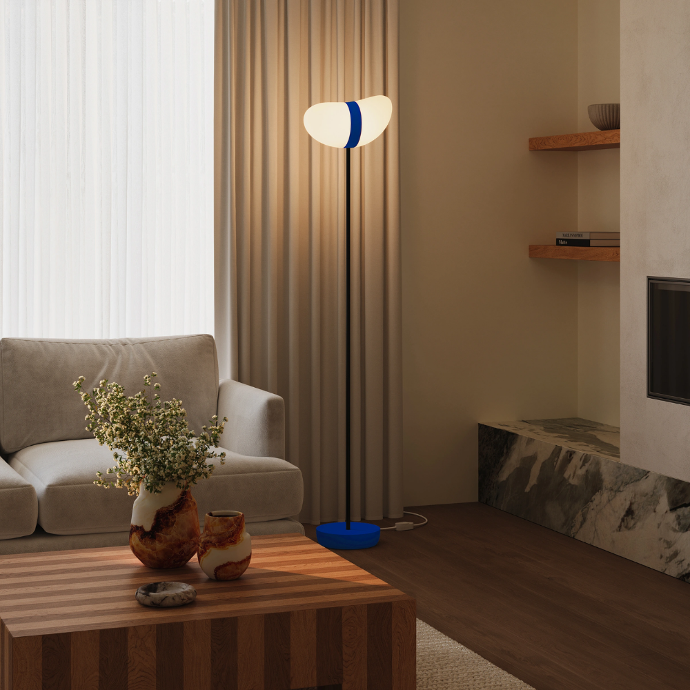 The cobalt Baltra Floor Light from Gantri with the black rod option in a living room.