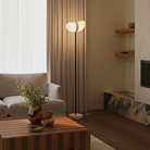 The coral Baltra Floor Light from Gantri with the black rod option in a living room.