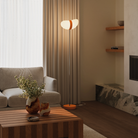 The persimmon Baltra Floor Light from Gantri with the chrome rod option in a family space.
