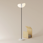 The snow Baltra Floor Light from Gantri with the black rod option.