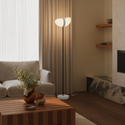 The stone Baltra Floor Light from Gantri with the black rod option in a living room.