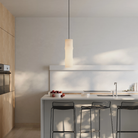 The Bamboo Medium Pendant Light from Gantri with the black cord in a kitchen and dining area.