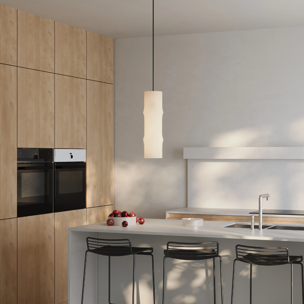 The Bamboo Medium Pendant Light from Gantri with the black cord in a living area.