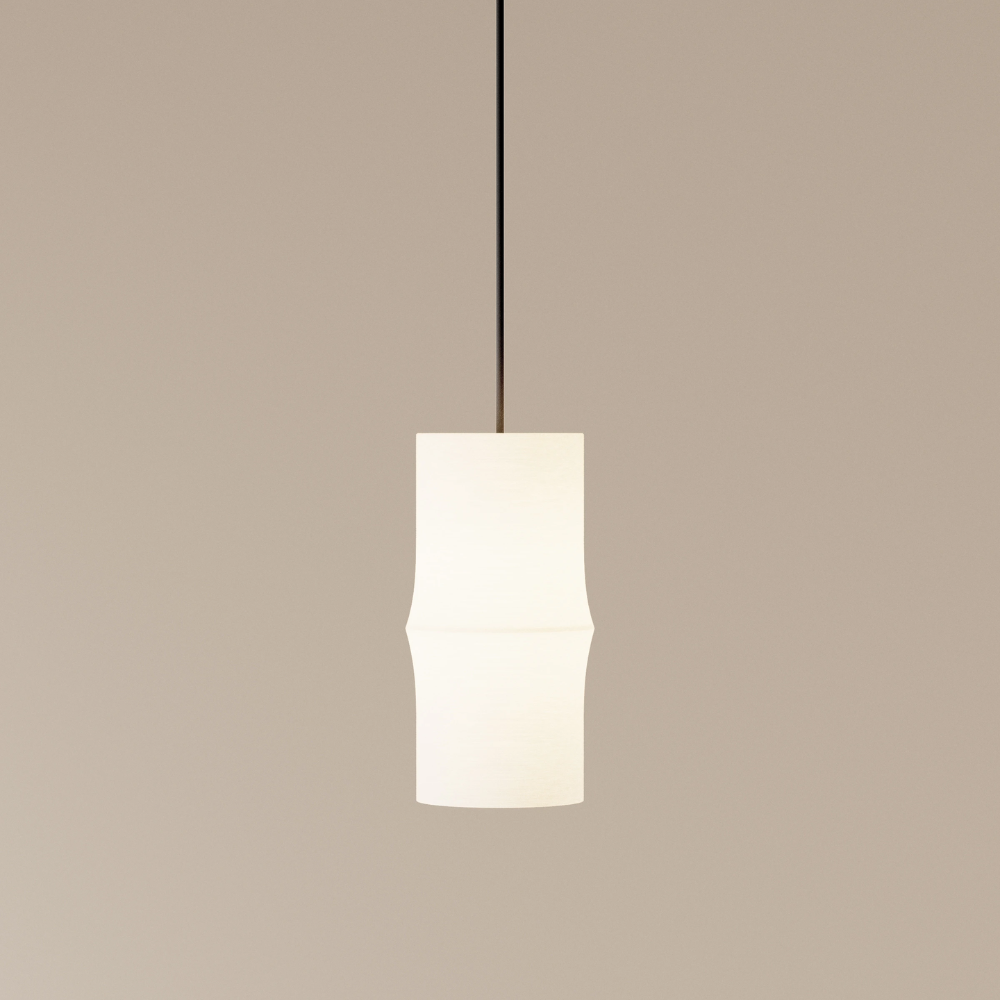 The Bamboo Small Pendant Light from Gantri with the black cord in a studio.