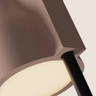 The coral Carve Floor Light from Gantri with the black rod option close up.