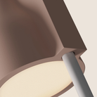 The coral Carve Floor Light from Gantri with the white rod option close up.
