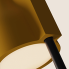 The mustard Carve Floor Light from Gantri with the black rod option close up.