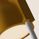 The mustard Carve Floor Light from Gantri with the white rod option close up.