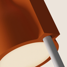 The persimmon Carve Floor Light from Gantri with the white rod option close up.
