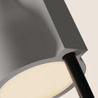 The stone Carve Floor Light from Gantri with the black rod option close up.