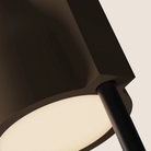 The walnut Carve Floor Light from Gantri with the black rod option close up.