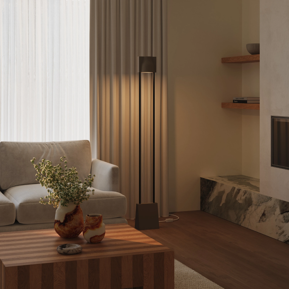 The walnut Carve Floor Light from Gantri with the black rod option in a living room.