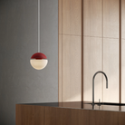 The canyon Cora Pendant Light from Gantri with the white cord in a living area.