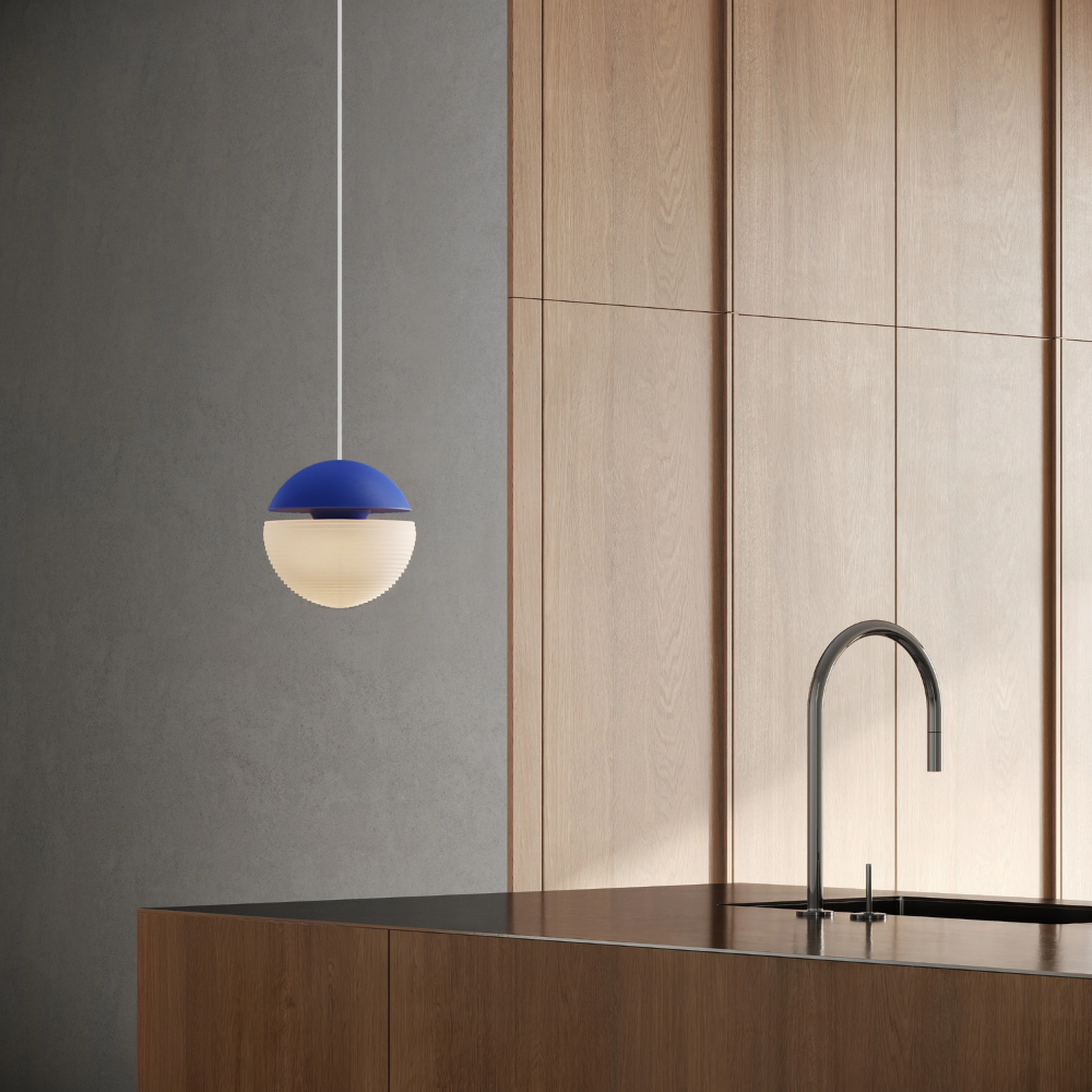 The cobalt Cora Pendant Light from Gantri with the white cord in a living room.