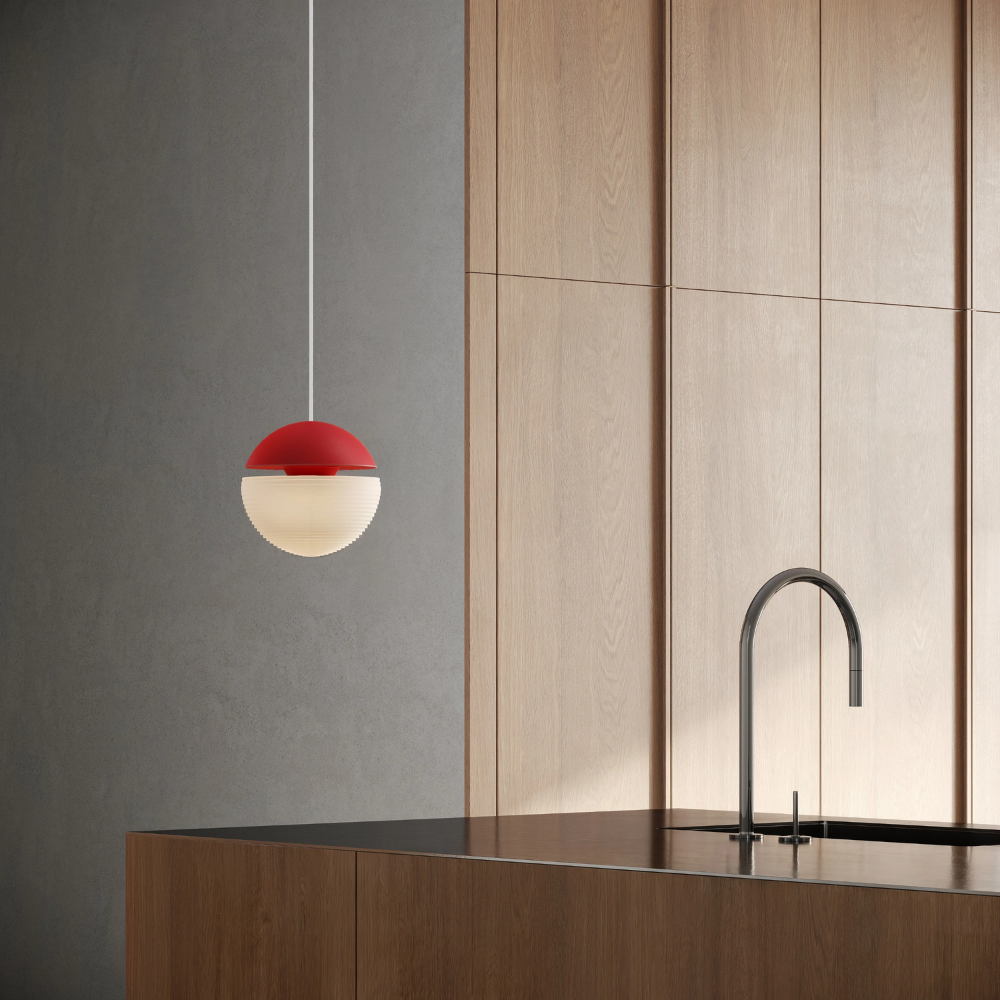 The poppy Cora Pendant Light from Gantri with the white cord in a living room.