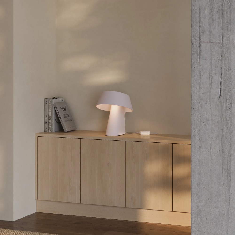 The coral Fold Table Light from Gantri in a living room.