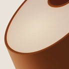 The persimmon Fold Table Light from Gantri close up.