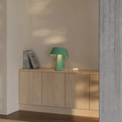 The sage Fold Table Light from Gantri in a living room.