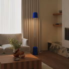 The cobalt Gio Floor Light from Gantri with the chrome rod option in a family space beside a sofa.