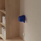 The cobalt Gio Wall Light from Gantri in a home office.