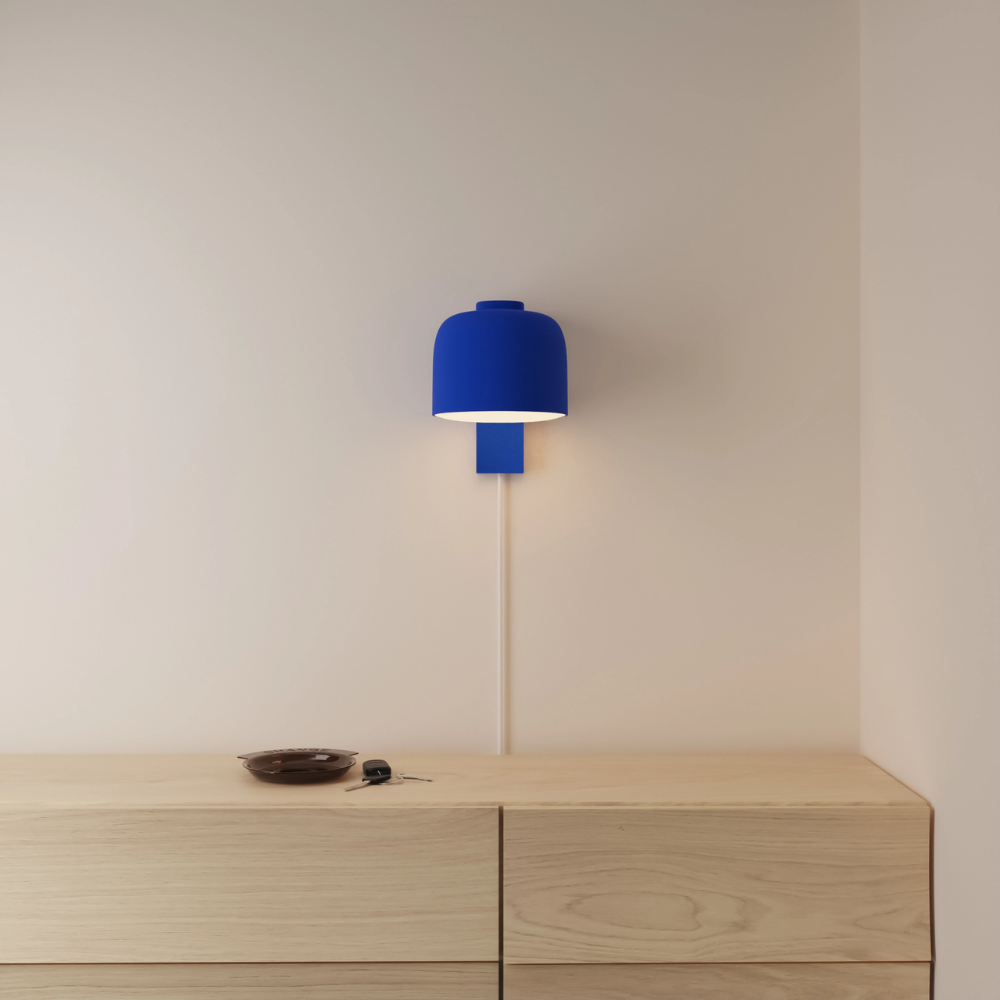 The cobalt Gio Wall Light from Gantri in a primary bedroom.