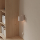 The coral Gio Wall Light from Gantri in a home office.