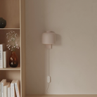 The coral Gio Wall Light from Gantri in a living room.